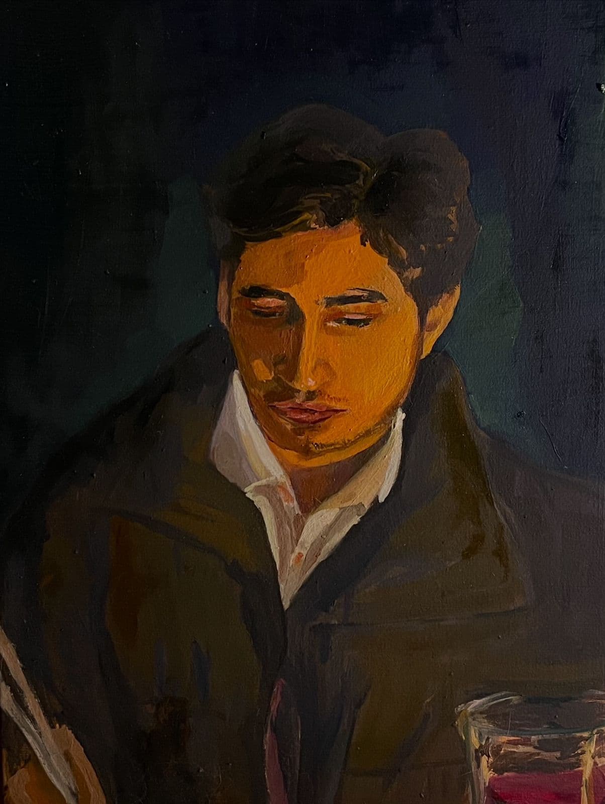 Oil portrait of a young man in low cafe lighting